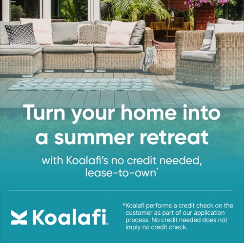 Outdoor deck with wicker furniture and beautiful landscaping